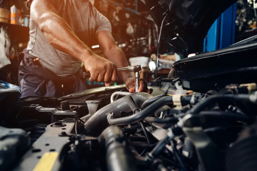 Mechanic working on car engine